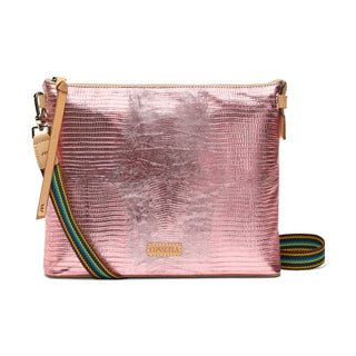 Pink textured crossbody bag with a colorful strap