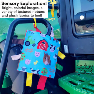 Farm animals crinkle toy hanging from tractor handle showing textured ribbons