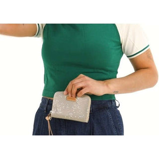 Person holding a small gray wallet