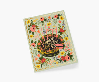 Rifle Paper Co. floral birthday card featuring a dark cake with pink candles and gold script