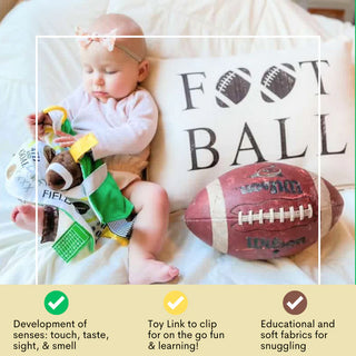 Newborn holding brown green yellow football sensory lovey with plush ball and toy link clip