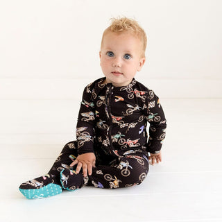 Baby wearing reversible zippered footie showing heart grip soles
