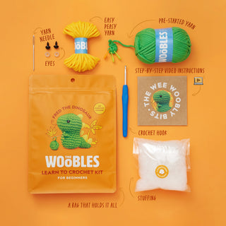 The Woobles Fred the Dinosaur beginner crochet kit with yarn, hook, stuffing, and instructions