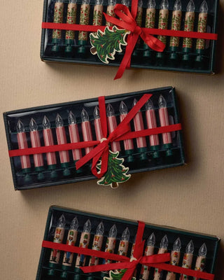 Three boxed sets of clip-on candle lights with red ribbon bows and Christmas tree tags