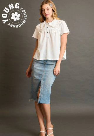 Woman wearing a white blouse and denim skirt with 'Young Contemporary' logo.