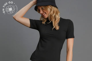 Woman wearing a black t-shirt and black bucket hat