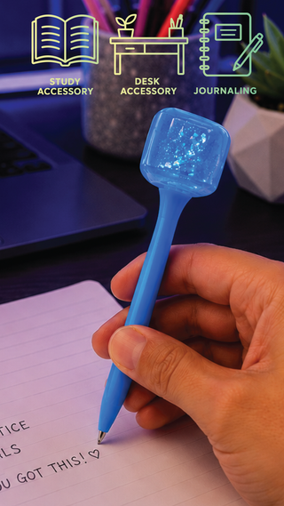 Blue squishy cube glitter pen being used to write in a notebook