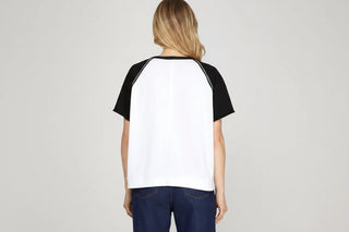 White and black raglan short sleeve color block knit top, back view