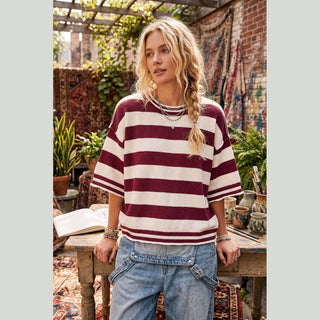 Close up maroon cream horizontal stripe knit fabric texture on relaxed fit women's top