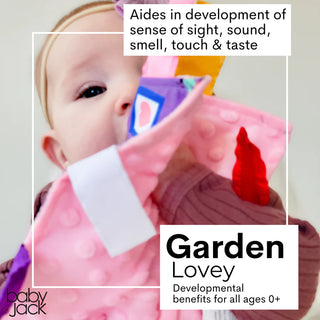 Baby holding purple sensory lovey emphasizing multi-textured ribbons and crinkle details