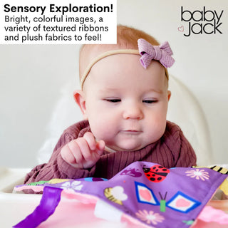 Infant gazing at purple garden sensory lovey with textured ribbons and heart frames