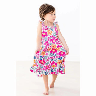 Young girl wearing a colorful floral dress 