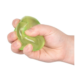lime green faceted Geo Squish Sugar Ball being squeezed by child hand showing gel texture