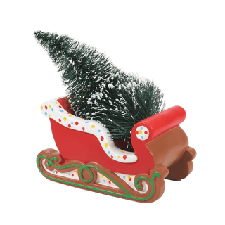 Red gingerbread-decorated Christmas sleigh with small evergreen tree and colorful polka dot trim
