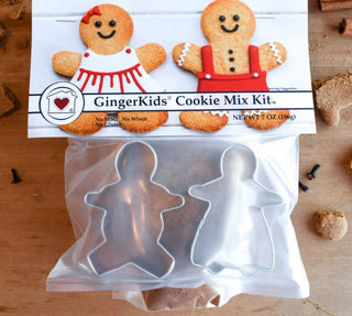 GingerKids Cookie Mix Kit with two metal gingerbread cookie cutters and spice mix inside clear packaging