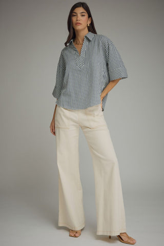 Full body navy gingham blouse outfit with high-waisted cream pants and strappy sandals