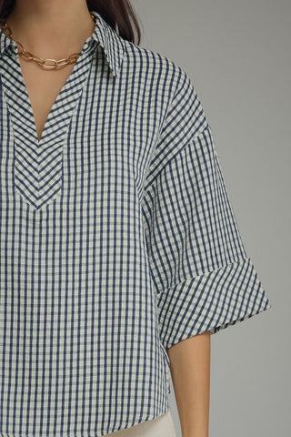 Navy gingham blouse V-neck close-up showing lightweight woven texture and rolled cuffs