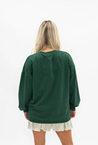 Oversized forest green crew neck sweatshirt shown from the back on a female model