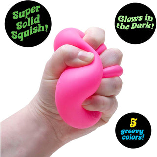 Hot pink Nee Doh Nice Cube Glow squishy toy being squeezed to show elasticity and rebound
