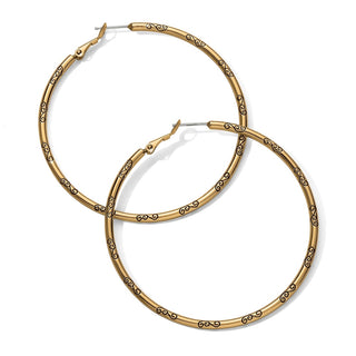 Close-up of Brighton Grande Hoop Charm Earrings gold finish with intricate black scroll engraving detail