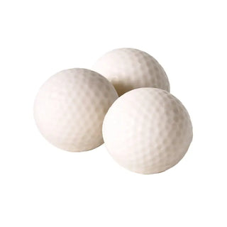 Three white golf ball-shaped soaps with dimpled texture grouped together