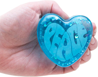 Hand holding teal NeeDoh squishy heart showing scale, grip, and glossy translucent material