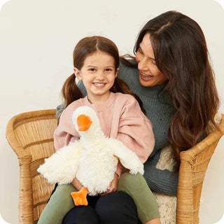 Child holding white plush goose toy for stress relief and better sleep