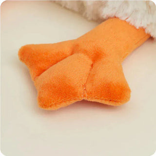 Close-up of white goose toy soft fluffy texture and orange webbed foot detail