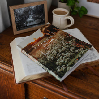 Grace in Chaos Bible study booklet resting on open Bible beside coffee mug