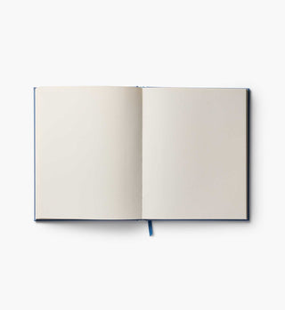 Open Rifle Paper Co. Gracie Embroidered Sketchbook showing blank cream pages with blue ribbon bookmark