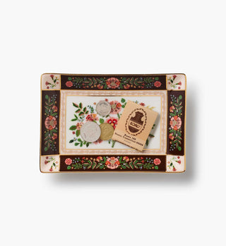 Gracie porcelain catchall tray with dark brown floral border holding coins and matchbook