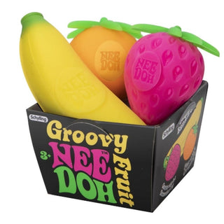 Dog toys shaped like fruit with 'Groovy Nee Doh' branding in a box.