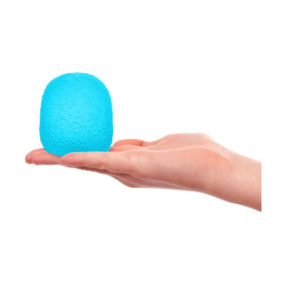 Bright cyan gumdrop-shaped squishy toy held in hand against white