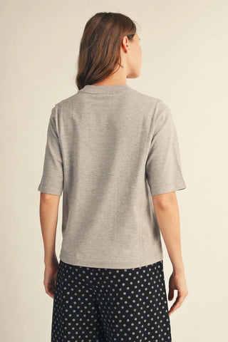 Gray heather half sleeve sweater top shown from the back on a female model