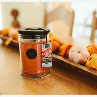 Bridgewater Harvest Pumpkin candle on rustic wood showing black handle lid and fall gourd paper tag