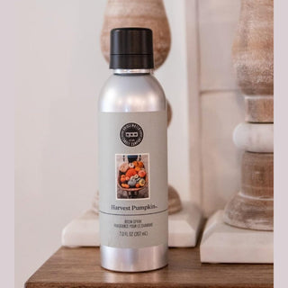Harvest Pumpkin room spray on rustic wood surface with warm fall decor for autumn home fragrance