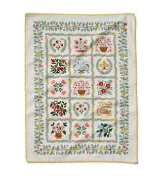 Embroidered tea towelwith floral and botanical patterns 