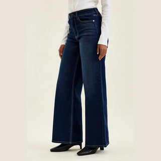 Close-up Judy Blue leather patch and embroidered back pocket detail on twilight blue jeans