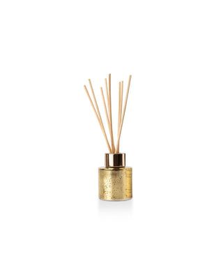 Aromatique Holiday Champagne Mini Reed Diffuser in gold mercury glass vessel with natural reeds