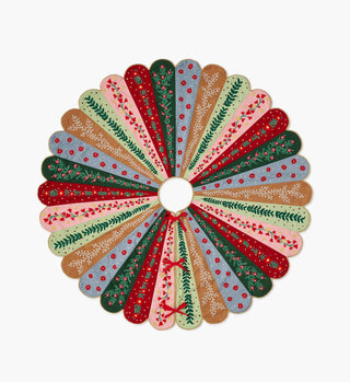 Rifle Paper Co. Holly Jolly embroidered Christmas tree skirt with colorful patchwork panels and floral motifs