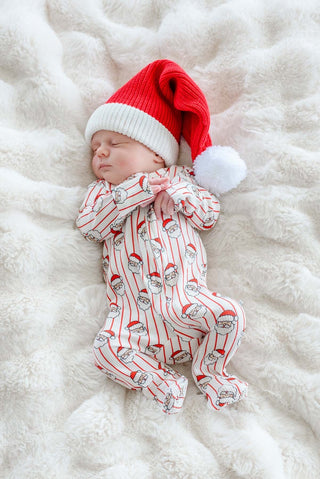 Sleeping newborn in Caden Lane Santa Claus print bamboo waffle zipper footie with matching Christmas hat