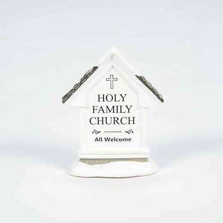 White miniature Holy Family Church building with cross and All Welcome text on clean background
