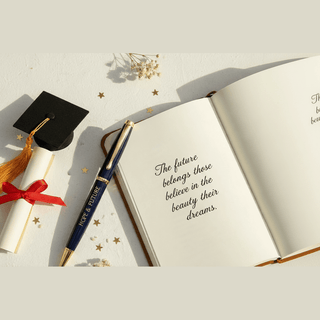 Flat lay of Hope & Future pen with graduation cap and diploma