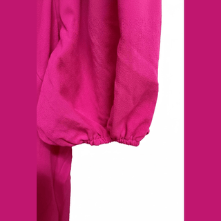 Flat-lay hot pink dress with V-neck, button placket, and puffed sleeves on white