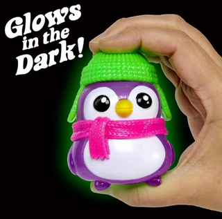 Purple glow-in-the-dark penguin stress ball toy with green knit hat and pink scarf