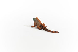 Schleich iguana figurine viewed from behind showing orange-brown body and striped tail
