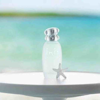 Inis unisex fragrance bottle upright on pedestal with starfish and turquoise water background