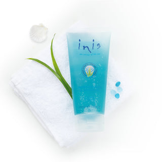 Blue tube of 'inis' product with a white flower