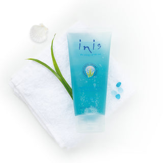 Blue tube of 'inis' product with a white flower