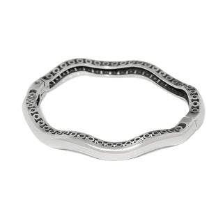 Brighton silver wavy bangle bracelet with circular cutout pattern along inner edge